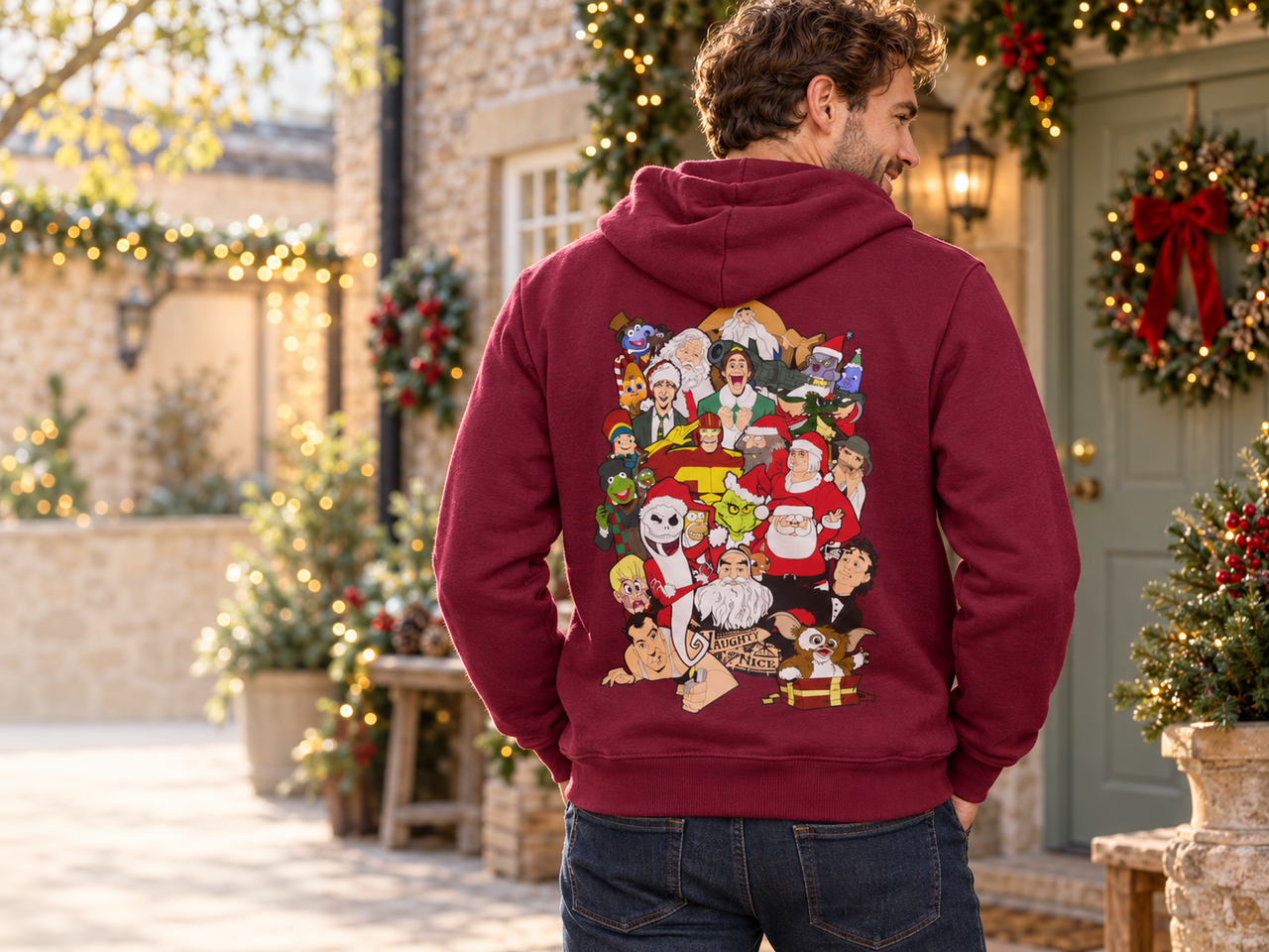 Model showing the back print of the burgundy Christmas Chaos hoodie in a decorated courtyard.