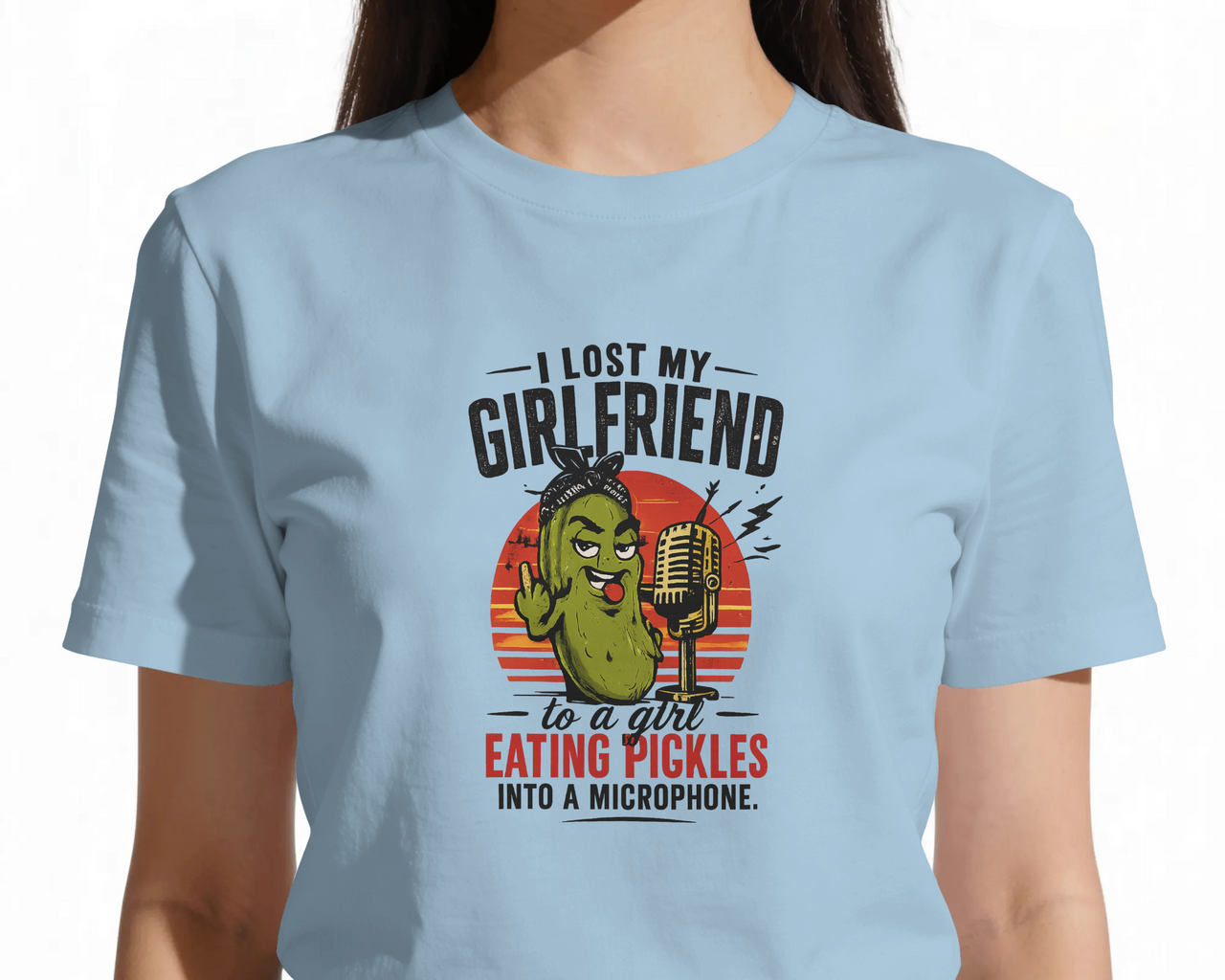 Light blue t-shirt with a pickle graphic and humorous text on a light blue  background. ASMR Took My Girl - The Pickle Whisperer