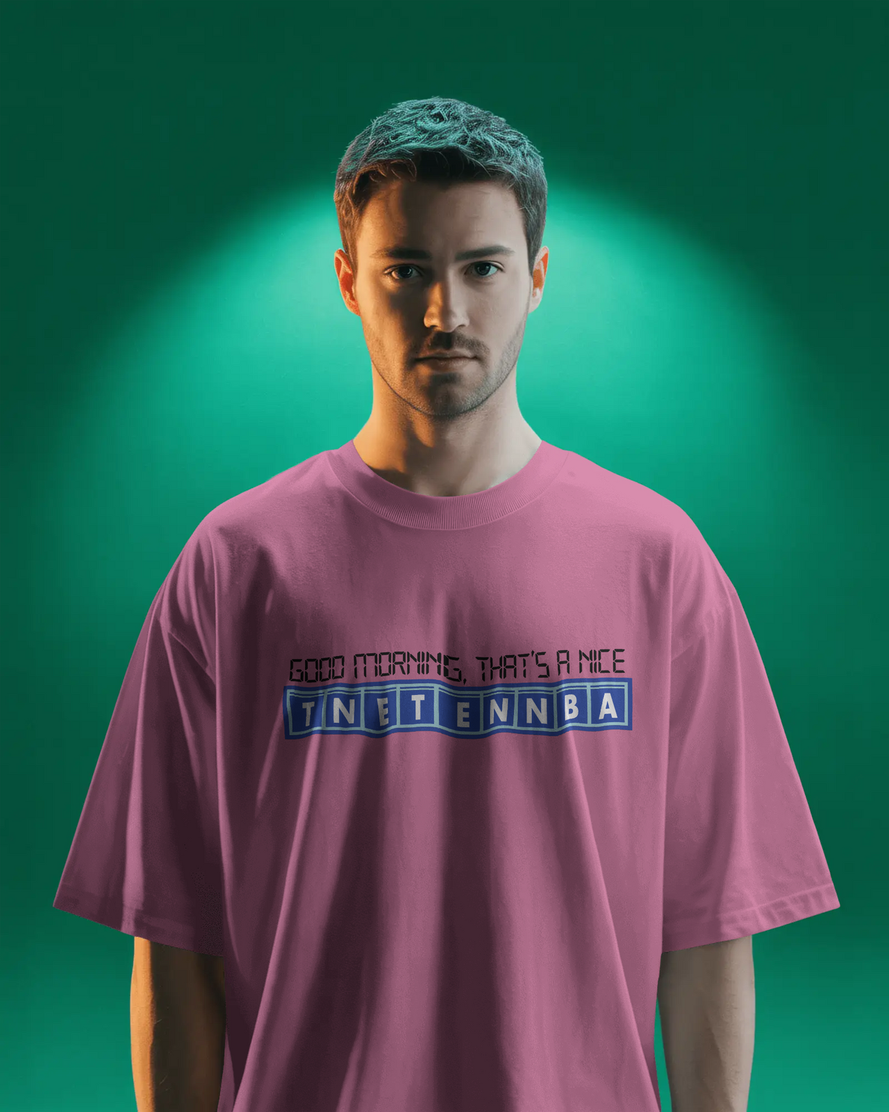 Person wearing a pink t-shirt with text on a green background - Good Morning That’s A Nice TNETENNBA - The IT Crowd T-Shirt