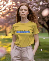 Thumbnail for Person wearing a yellow t-shirt with text in a park - Good Morning That’s A Nice TNETENNBA - The IT Crowd T-Shirt