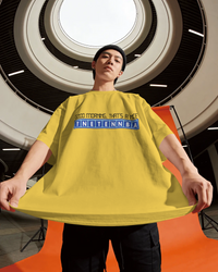 Thumbnail for Person wearing a yellow oversized t-shirt with text in an indoor setting - Good Morning That’s A Nice TNETENNBA - The IT Crowd T-Shirt