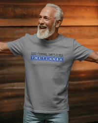 Thumbnail for Man wearing a gray t-shirt with text, standing against a wooden background - Good Morning That’s A Nice TNETENNBA - The IT Crowd T-Shirt