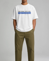 Thumbnail for Person wearing a white t-shirt with text and green pants on a gray background - Good Morning That’s A Nice TNETENNBA - The IT Crowd T-Shirt