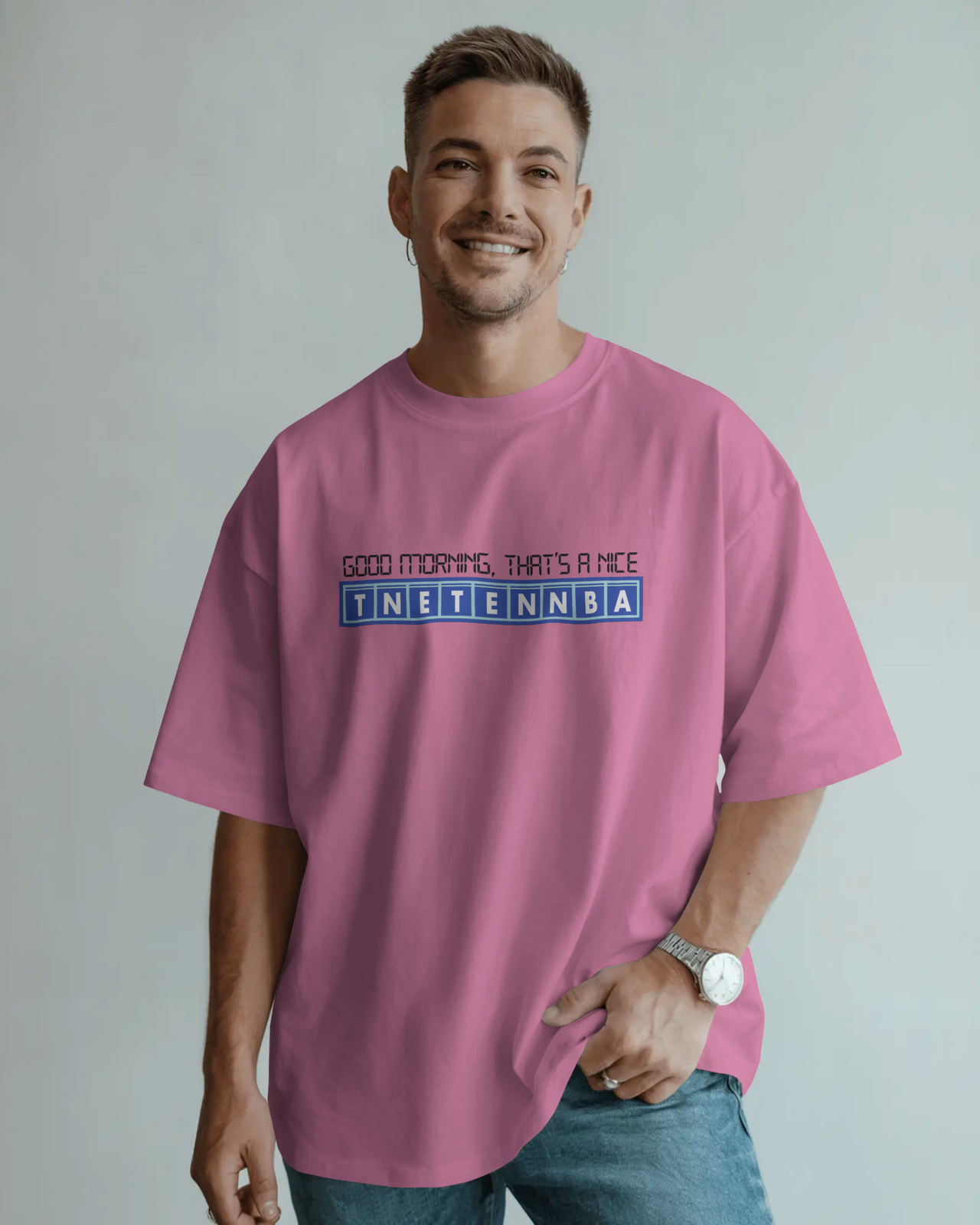 Man wearing a pink t-shirt with text on a plain background - IT Crowd - Tnetennba