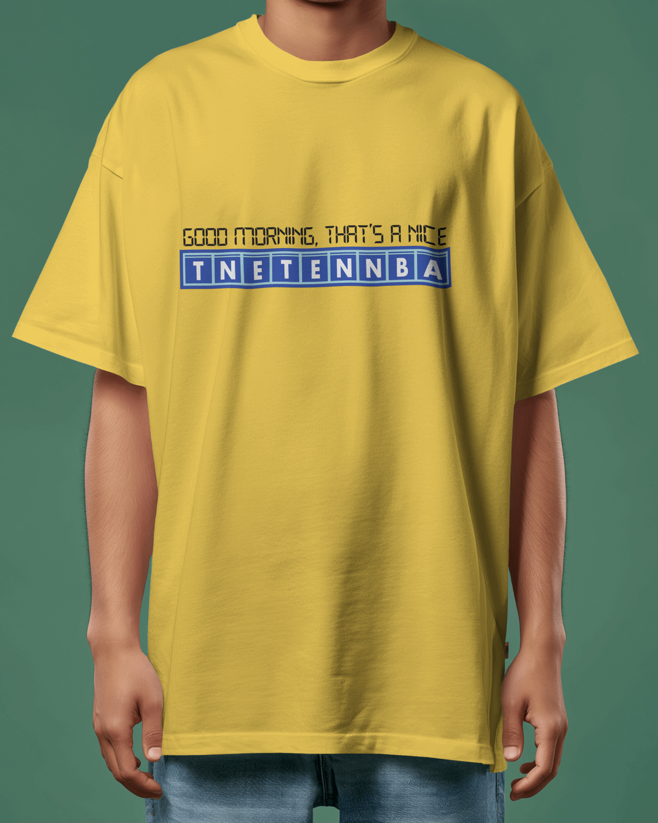 Person wearing a yellow t-shirt with text and logo on a green background - IT Crowd - Tnetennba