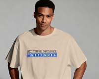 Thumbnail for Man wearing a beige t-shirt with text on a grey background - IT Crowd - Tnetennba