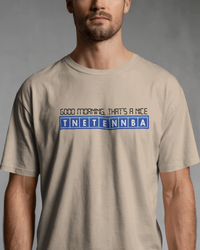 Thumbnail for Man wearing a beige t-shirt with text design on a gray background - Good Morning That’s A Nice TNETENNBA - The IT Crowd T-Shirt