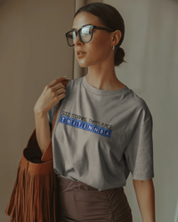 Thumbnail for Woman wearing a grey t-shirt with text, standing indoors. - IT Crowd - Tnetennba
