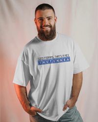 Thumbnail for Man wearing a white t-shirt with text on a plain background - IT Crowd - Tnetennba