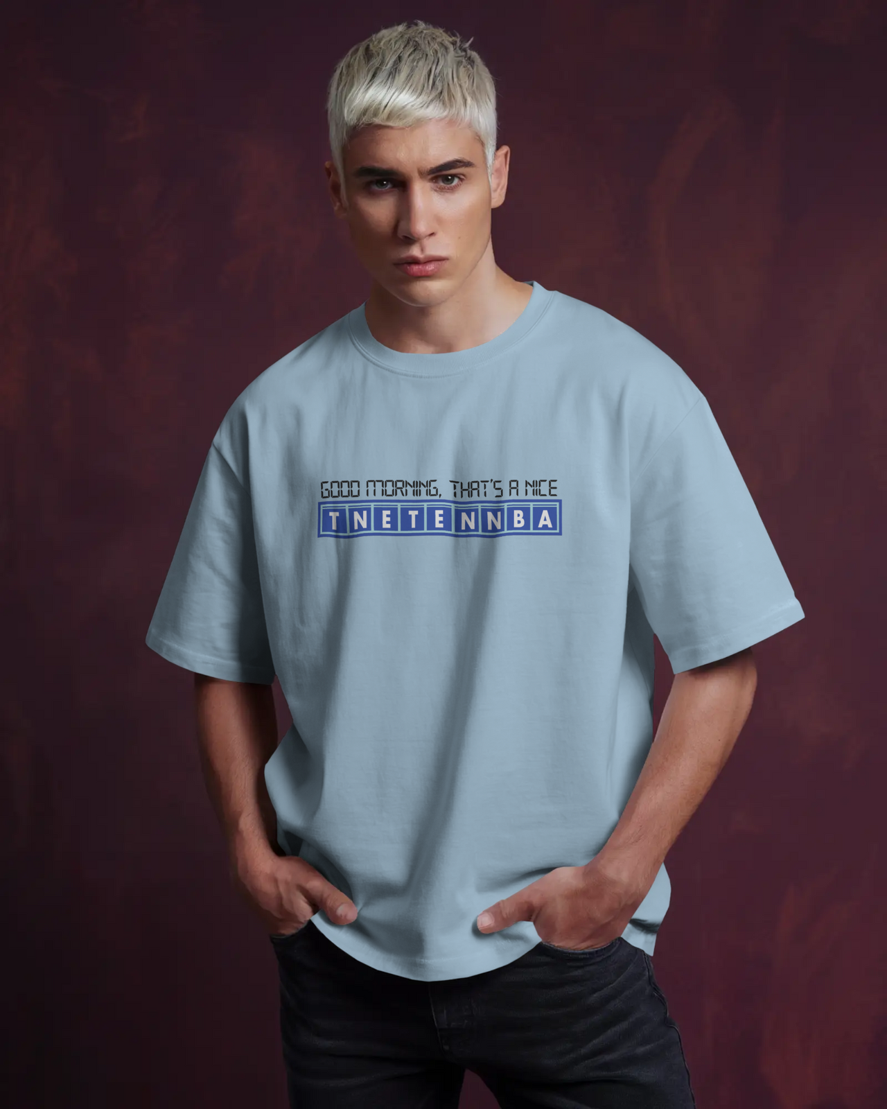 Person wearing a light blue t-shirt with text on a dark background - IT Crowd - Tnetennba