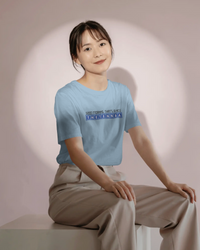 Thumbnail for Person wearing a light blue t-shirt with text, sitting against a plain background - IT Crowd - Tnetennba