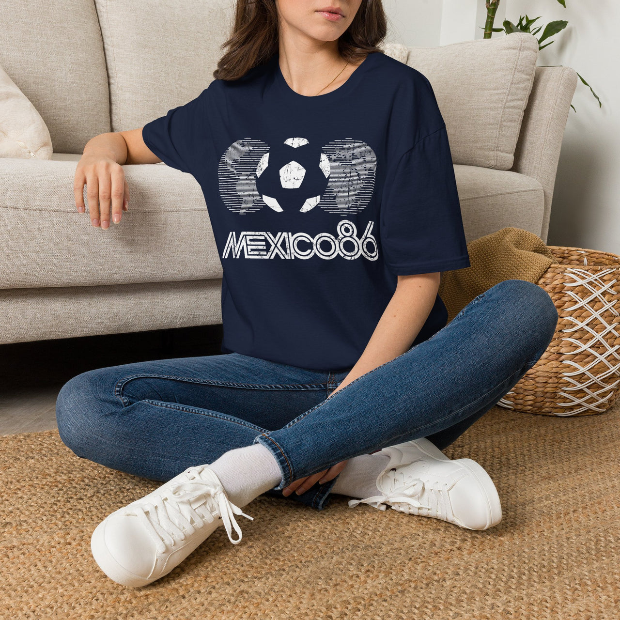 Person wearing a navy blue Vintage t-shirt with 'Mexico 86' design sitting on a carpeted floor. World Cup 2026