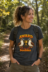 Thumbnail for Woman wearing the Award for the Best Boobies T-Shirt in Dark Heather while enjoying a woodland walk on an autumn day.