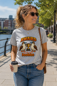 Thumbnail for Woman wearing the Award for the Best Boobies T-Shirt in Sport Grey while walking along a riverside promenade.