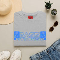 Thumbnail for A folded sport gray T-shirt with a blue and white 'BASS THE FINAL FRONTIER' graphic across the chest, styled in a flat lay with a straw hat, white sneakers, blue jeans, sunglasses, and small potted succulents on a beige background.