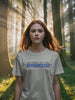 Girl in forest video wearing a white IT Crowd - Tnetennba t-shirt - Good Morning That’s A Nice TNETENNBA