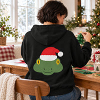 Thumbnail for Santa Frog Christmas Back Print Hoodie in Black, worn in a Christmas home setting with the Santa frog back print visible.