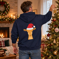 Thumbnail for Santa Giraffe Christmas Back Print Hoodie in Navy, worn in a Christmas home setting with the Santa giraffe back print visible.