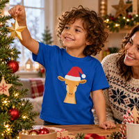 Thumbnail for Santa Giraffe Christmas Kids T-Shirt in Royal, worn in a Christmas home setting with the Santa giraffe front print visible.