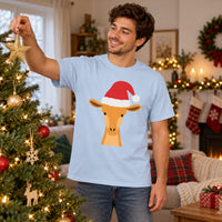 Thumbnail for Santa Giraffe Christmas Unisex T-Shirt in Light Blue, worn in a Christmas home setting with the Santa giraffe front print visible.