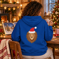 Thumbnail for Santa Lion Christmas Back Print Hoodie in Royal, worn in a Christmas home setting with the Santa lion back print visible.