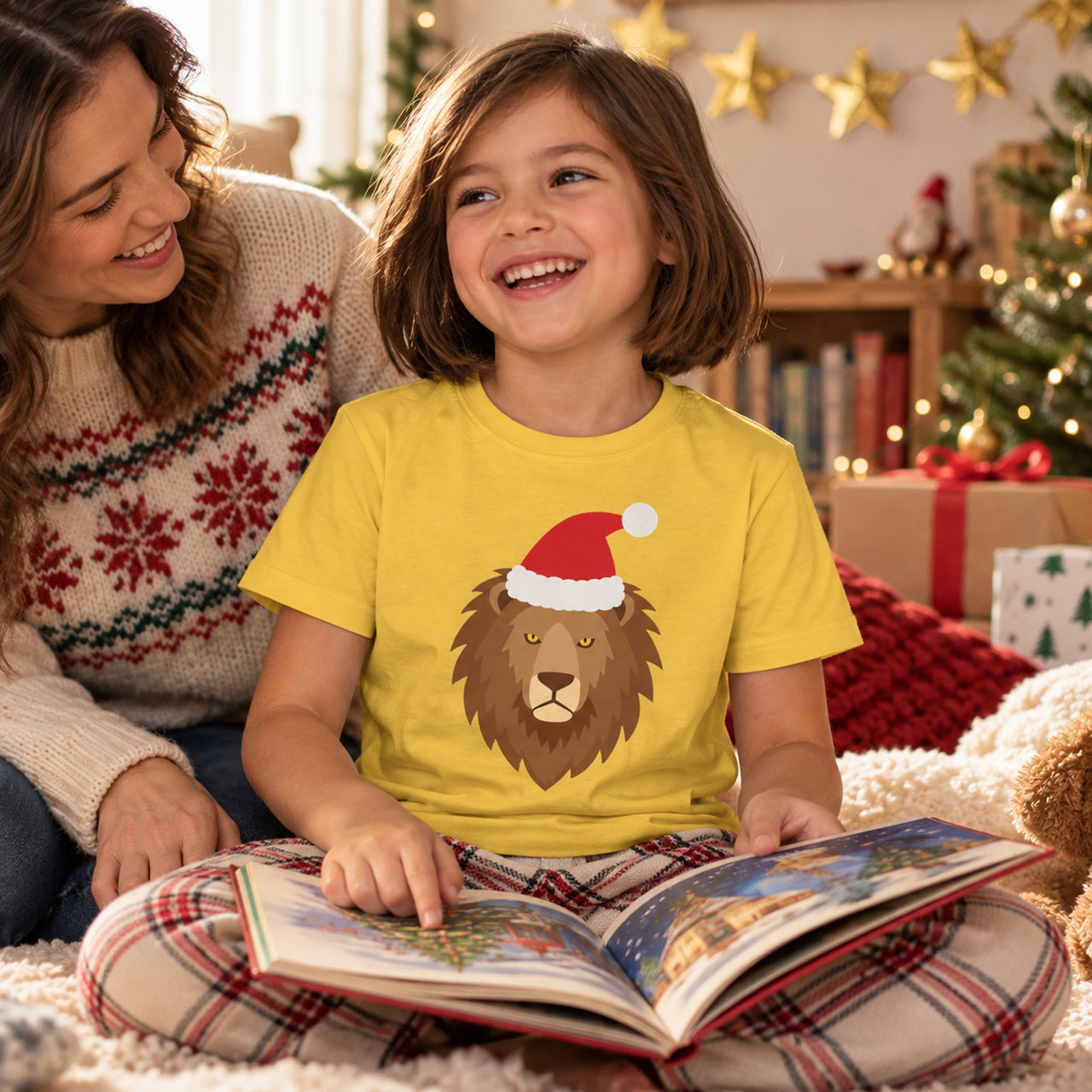 Santa Lion Christmas Kids T-Shirt in Daisy, worn in a Christmas home setting with the Santa lion front print visible.