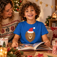 Thumbnail for Santa Lion Christmas Kids T-Shirt in Royal, worn in a Christmas home setting with the Santa lion front print visible.