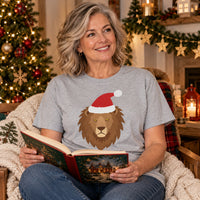 Thumbnail for Santa Lion Christmas Unisex T-Shirt in Sport Grey, worn in a Christmas home setting with the Santa lion front print visible.