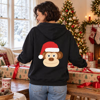 Thumbnail for Santa Monkey Christmas Back Print Hoodie in Black, worn in a Christmas home setting with the Santa monkey back print visible.