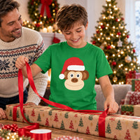 Thumbnail for Santa Monkey Christmas Kids T-Shirt in Irish Green, worn in a Christmas home setting with the Santa monkey front print visible.