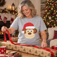 Thumbnail for Santa Monkey Christmas Unisex T-Shirt in Sport Grey, worn in a Christmas home setting with the Santa monkey front print visible.