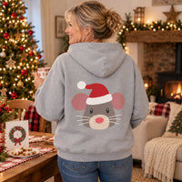 Thumbnail for Santa Mouse Christmas Back Print Hoodie in Sport Grey, worn in a Christmas home setting with the Santa mouse back print visible.
