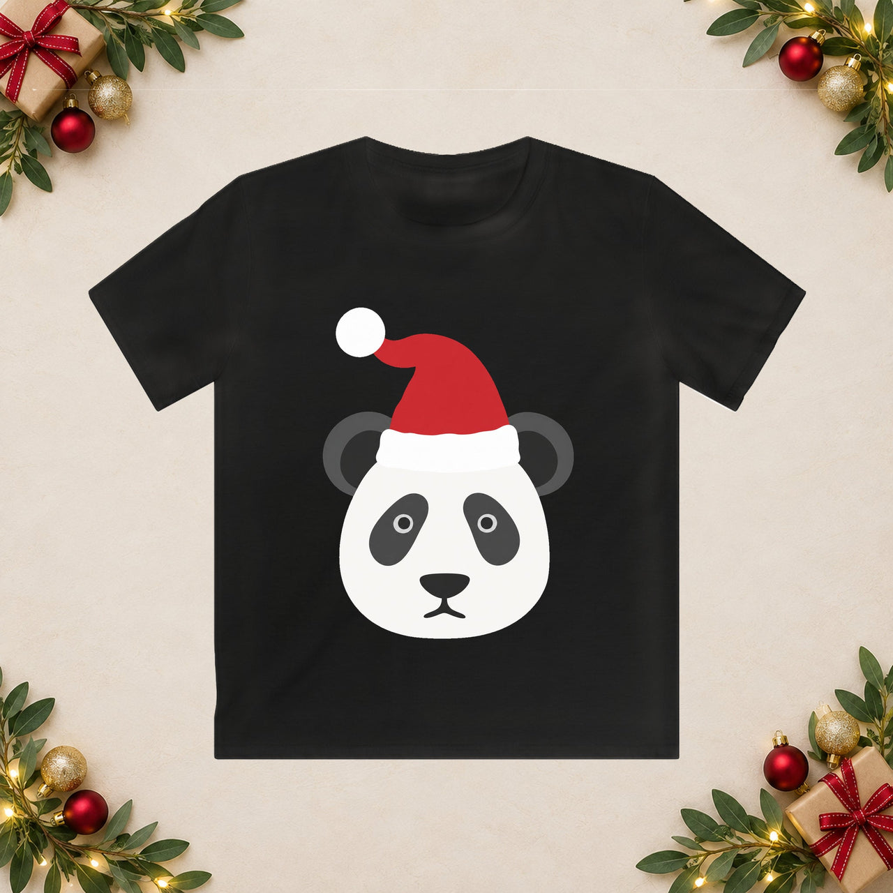 Santa Panda Christmas Kids T-Shirt in Black, front print with a Santa panda illustration on a Christmas flat-lay background.