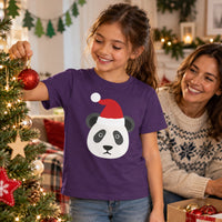 Thumbnail for Santa Panda Christmas kids t shirt in Purple, worn in a festive home setting with the Santa panda front print visible.