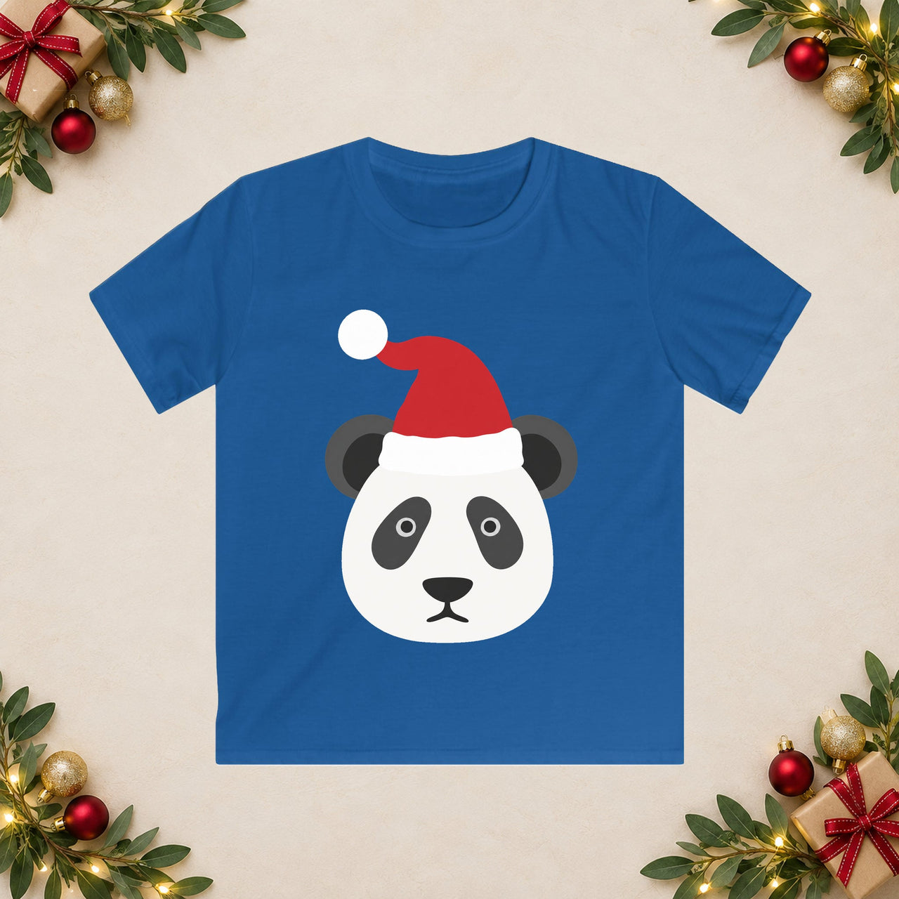 Santa panda Christmas kids t shirt in Royal, front view with the Santa animal illustration on a Christmas flat-lay background.