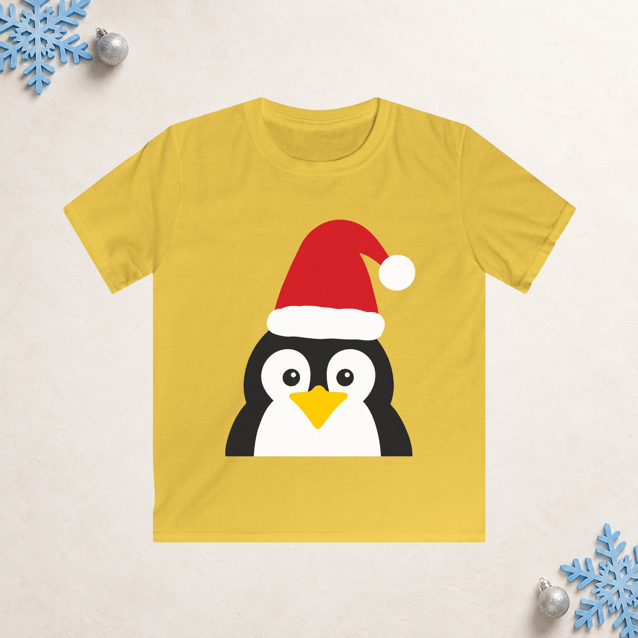 Santa penguin Christmas kids t shirt in Daisy, front view with the Santa animal illustration on a Christmas flat-lay background.