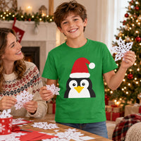 Thumbnail for Santa Penguin Christmas kids t shirt in Irish Green, worn in a Christmas home setting with the Santa penguin front print visible.