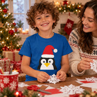 Thumbnail for Santa Penguin Christmas kids t shirt in Royal, worn in a Christmas home setting with the Santa penguin front print visible.