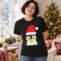 Thumbnail for Santa Penguin Christmas unisex t shirt in Black, worn in a Christmas home setting with the Santa penguin front print visible.