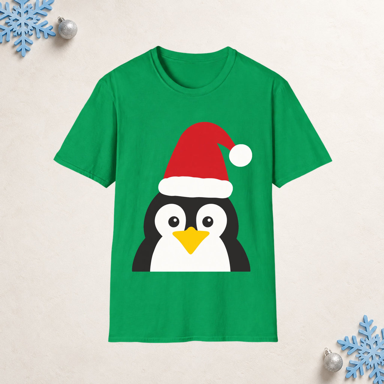 Santa penguin Christmas unisex t shirt in Irish Green, front view with the Santa animal illustration on a Christmas flat-lay background.