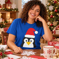 Thumbnail for Santa Penguin Christmas unisex t shirt in Royal, worn in a Christmas home setting with the Santa penguin front print visible.