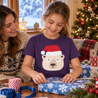 Thumbnail for Santa Polar Bear Christmas kids t shirt in Purple, worn in a Christmas home setting with the Santa polar bear front print visible.