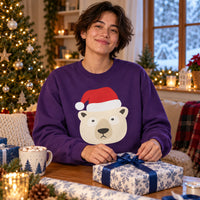 Thumbnail for Santa Polar Bear Christmas sweatshirt in Purple, worn in a Christmas home setting with the Santa polar bear front print visible.