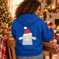 Thumbnail for Santa Sheep Christmas Back Print Hoodie in Royal, worn in a Christmas home setting with the Santa sheep back print visible.