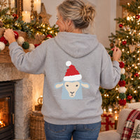 Thumbnail for Santa Sheep Christmas Back Print Hoodie in Sport Grey, worn in a Christmas home setting with the Santa sheep back print visible.