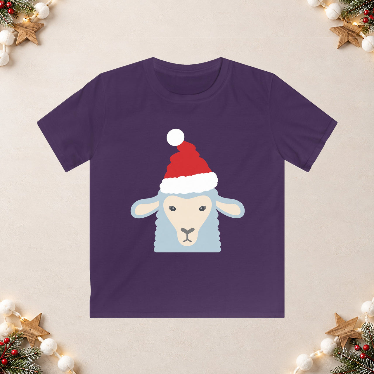 Santa sheep Christmas kids t shirt in Purple, front view with the Santa animal illustration on a Christmas flat-lay background.