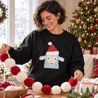 Thumbnail for Santa Sheep Christmas Sweatshirt in Black, worn in a Christmas home setting with the Santa sheep front print visible.