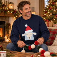 Thumbnail for Santa Sheep Christmas Sweatshirt in Navy, worn in a Christmas home setting with the Santa sheep front print visible.