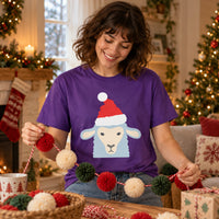 Thumbnail for Santa Sheep Christmas Unisex T-Shirt in Purple, worn in a Christmas home setting with the Santa sheep front print visible.