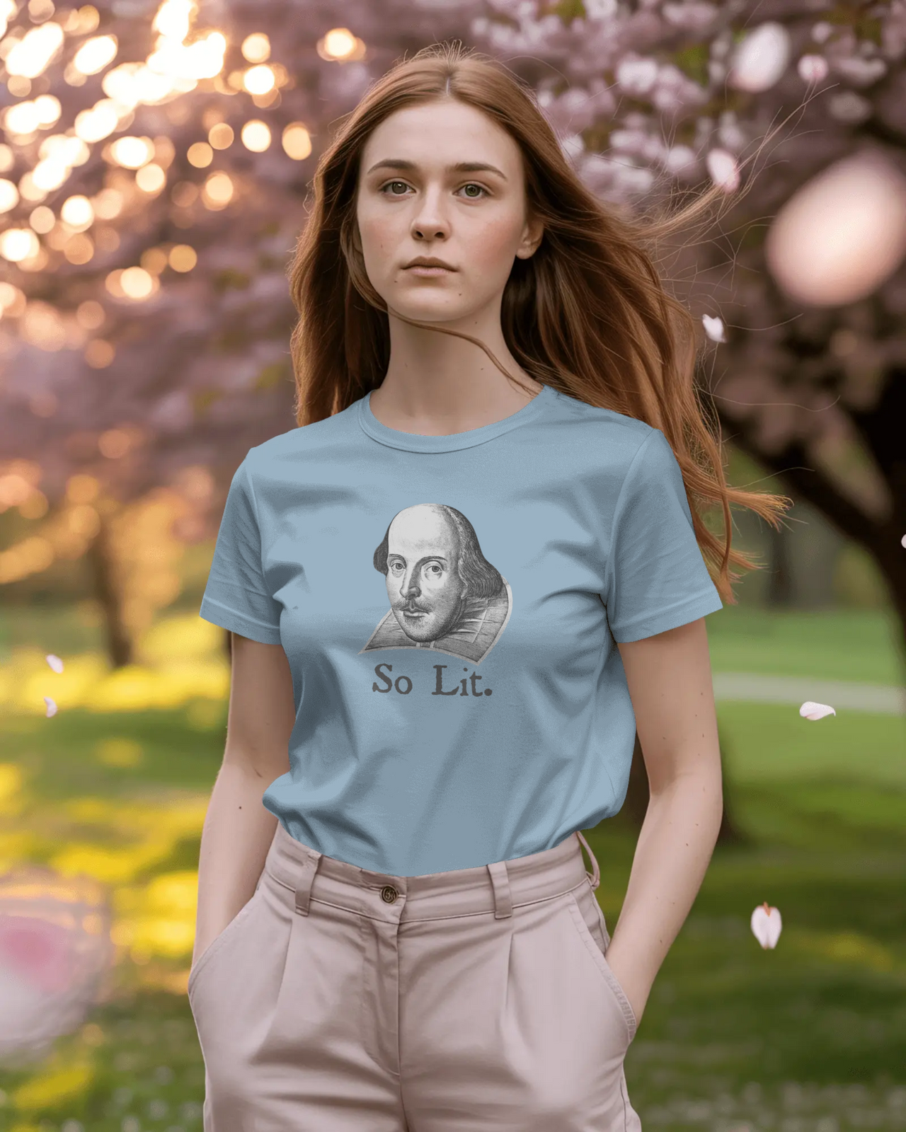 Shakespeare So Lit women’s fitted t-shirt in Light Blue, worn outdoors in a spring garden setting